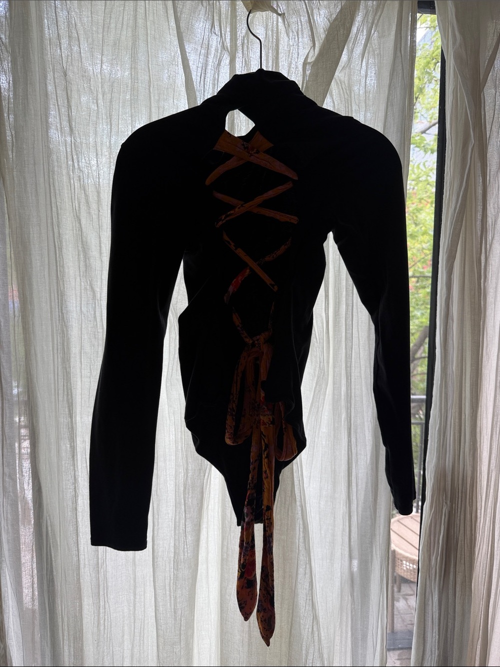 Free People Black Turtleneck Bodysuit with open lace-up back detailing.